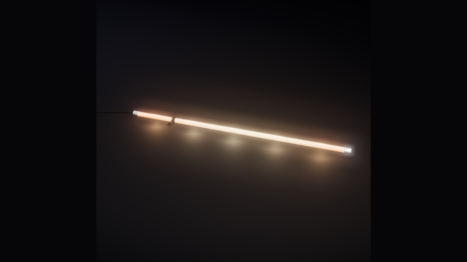 A 1 m sample of Spaghetti pixel LED rope with steel end caps, lit warm, on a dark surface